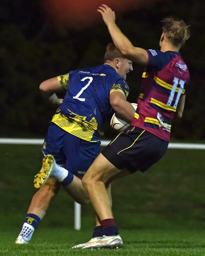 A Brunel forward in the number two shirt closes down an opposition kicker on the touchline.
